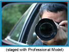 Man in a car taking a photo with a telephoto lens (Staged with Professional Model).