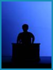 Black silhouette of man at a podium. (Staged with a professional model).
