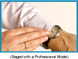 Close up of man with white long sleeve shirt looking at his watch (staged with professional model).