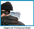 Man wearing ski hat, black mask, and gloves holding social security and credit cards.  (staged with professional model).