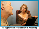 Woman with clipboard looking at man's profile.