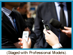 Close of  reporters interviewing a man in a suit.